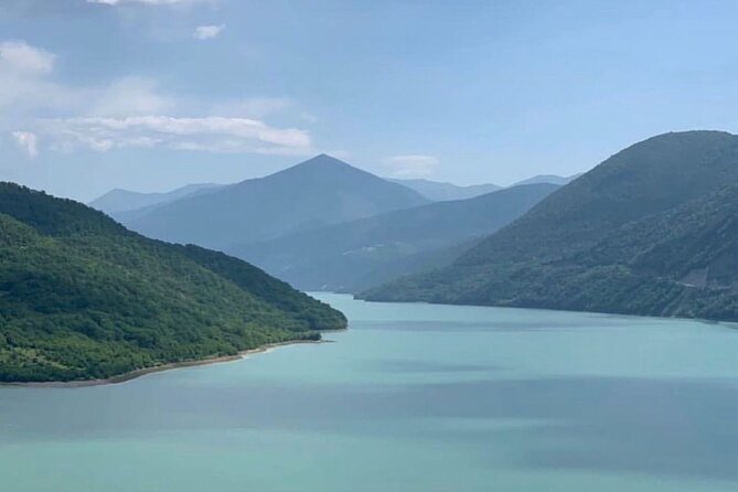 Day tour to mountains Jinvali lake, Ananuri, Kazbegi, Arch friendship - Zhinvali Reservoir: turquoise water below the highway